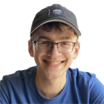 Man with baseball cap smiling at camera