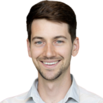 Man with dark hair and beard smiling at camera