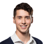 Man with dark hair smiling at camera